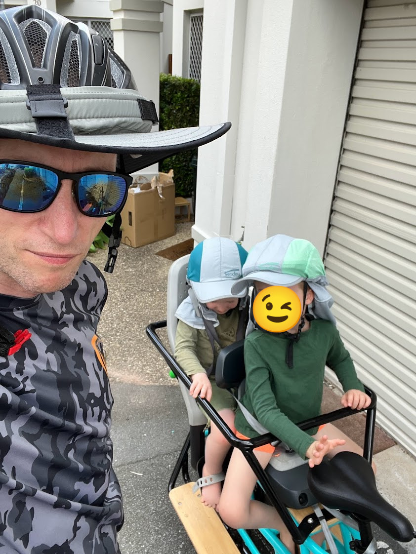 Me, with brimmed helmet and sunglasses, and my two kids sitting on the Tribe Evamos, wearing legionaires style helmet covers.